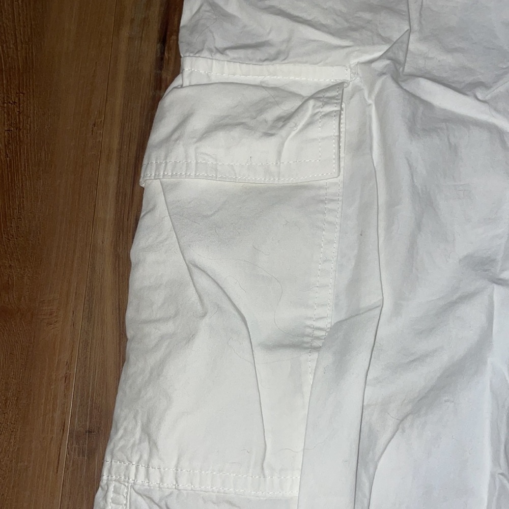 White parachute cargo pants. That tie at the bottom and top.